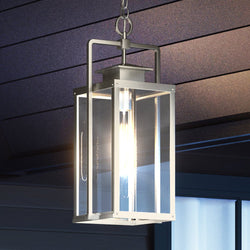 A UEX1033 Lux Industrial Outdoor Pendant 22''H x 9''W, Burnished Aluminum Finish, Knoxville Collection light fixture hanging from the ceiling of a house, creating a unique ambiance