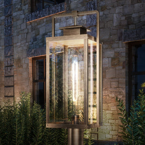 A unique luxury lighting fixture, an Urban Ambiance Lux Industrial Outdoor Post Light, in front of a stone building.