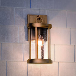 A beautiful Urban Ambiance UEX1045 Nautical Outdoor Wall Sconce 14''H x 7''W, Antique Brass Finish, Rockland Collection with a light bulb.