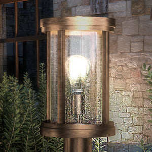 A gorgeous UEX1049 Nautical Outdoor Post Light 15''H x 8''W, Antique Brass Finish, Rockland Collection by Urban Ambiance with a light bulb in it.