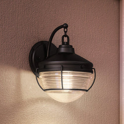 A Unique UEX1051 Nautical Outdoor Wall Sconce with a glass shade.