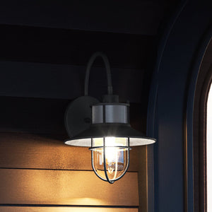A gorgeous Nautical Outdoor Wall Sconce 14''H x 10''W, Charcoal Finish from the Malibu Collection on a wooden wall.