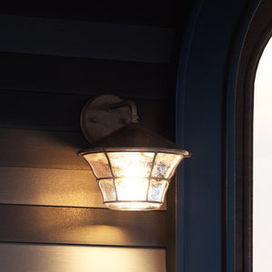 A beautiful UE1071 Nautical Outdoor Wall Sconce lighting fixture on a wall next to a window.