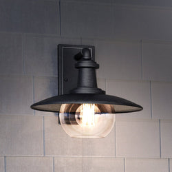 A gorgeous Urban Ambiance UEX1091 Farmhouse Outdoor Wall Sconce 12''H x 13''W in Matte Black Finish on a tiled wall.