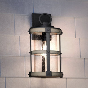 A beautiful Urban Ambiance UEX1101 Farmhouse Outdoor Wall Sconce 16''H x 8''W with a glass shade.