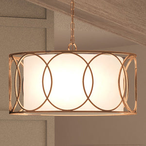 A unique UEX2032 Cosmopolitan Chandelier 15''H x 28''W, Matte Gold Finish, Corvallis Collection with a white shade hanging over a wooden ceiling
