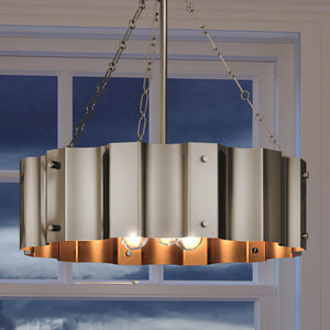 A unique UEX2041 Lux Industrial Chandelier with a Matte Nickel finish, hanging over a window.