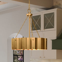 A unique and beautiful UEX2047 Lux Industrial Chandelier 23''H x 21''W, Native Brass Finish, Claremore Collection pendant light hanging over a kitchen island.