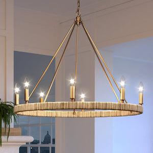 A gorgeous lighting fixture from the Rutherford Collection, the UEX2081 Bohemian Chandelier in Satin Brass Finish is hanging over a fireplace in a beautiful living room.