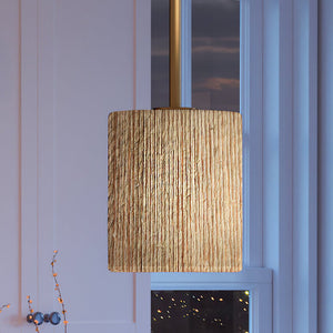 A luxury lighting fixture, the UEX2088 Bohemian Pendant with a Satin Brass Finish from the Rutherford Collection is hanging over a window in a living room.