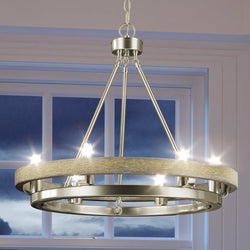 A unique UEX2106 Rustic Chandelier, Satin Nickel Finish, Burlington Collection hanging over a window in a living room.