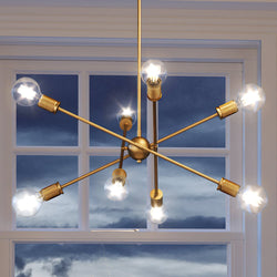 A beautiful UEX2161 Mid-Century Modern Chandelier with an Olde Brass Finish from the Berlin Collection by Urban Ambiance hanging in front of a window.