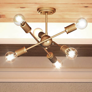 A beautiful and unique UE22162 Mid-Century Modern Ceiling Lamp with an Olde Brass Finish, Berlin Collection light fixture with four bulbs hanging from a wooden ceiling, made by Urban Ambiance.