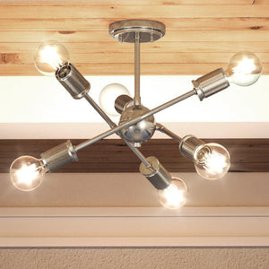A beautiful and luxurious Mid-Century Modern ceiling light with five bulbs hanging from the ceiling.