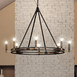 A gorgeous UEX2191 Lux Industrial Chandelier 30''H x 38''W, Oil Rubbed Bronze & Satin Brass Finish, Stillwater Collection hanging from a brick wall