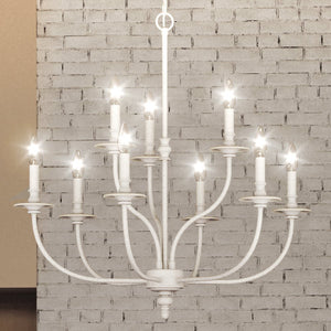 A gorgeous UEX2262 Cottagecore Chandelier 28''H x 29''W, Weathered White Finish, Everett Collection lighting fixture hanging from a brick wall.