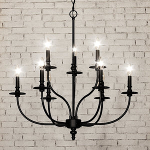 A unique lighting fixture, the UEX2266 Cottagecore Chandelier in Oil Rubbed Bronze Finish from the Everett Collection by Urban Ambiance elegantly hangs from a brick wall.