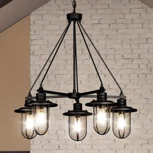 A gorgeous lighting fixture, the Urban Ambiance UEX2284 Nautical Chandelier, features glass bulbs hanging in front of a brick wall.