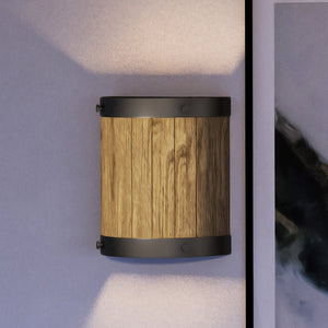 A unique and beautiful UEX2301 Old World Wall Sconce 10''H x 9''W, Oil Rubbed Bronze Finish, Portland Collection by Urban Ambiance next to a painting