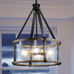 A unique Urban Ambiance UEX2356 Industrial Lux Chandelier, with a charcoal & olde brass finish from the Elwood Collection, providing luxury lighting above a window in a room.