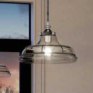 A beautiful UEX2410 Craftsman Pendant lamp hangs luxuriously over a window.