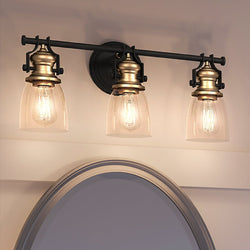 Three unique UEX2459 New Traditional Bath Light 10''H x 23''W, Oil Rubbed Bronze & Satin Brass Finish, Winsted Collection bathroom fixture with a