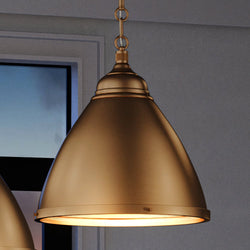 Two UEX2471 Lux Industrial Pendant 16''H x 15''W, Satin Brass Finish, Waterford Collection pendant lights hanging above a window, creating a gorgeous lighting fixture.