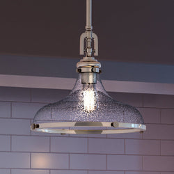 A unique pendant lamp with a glass shade in an urban kitchen.