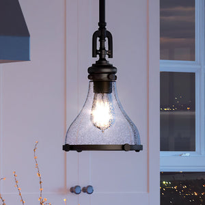 A beautiful UEX2515 Vail Collection pendant light with an Oil Rubbed Bronze Finish hanging over a kitchen.