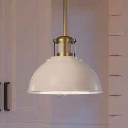 A unique Georgetown Collection pendant light, UEX2521 Cosmopolitian Pendant 8''H x 10''W, Native Brass & True White Finish, hanging over a kitchen island