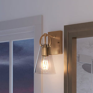 A beautiful bathroom with a UEX2544 New Traditional Wall Sconce 11''H x 4.75''W, Native Brass Finish, Irvine Collection from Urban Ambiance and