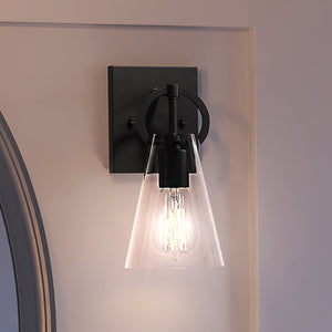 A beautiful UEX2548 New Traditional Wall Sconce 11''H x 4.75''W, Matte Black Finish, Irvine Collection wall sconce with a clear glass shade from
