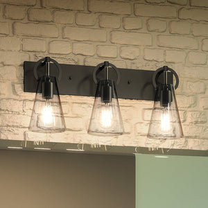 Three luxury UEX2550 New Traditional Bath Light 10''H x 23''W, Matte Black Finish, Irvine Collection fixtures hanging above a brick wall.