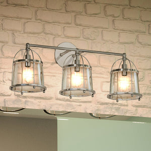 Three gorgeous Urban Ambiance lighting fixtures hanging over a brick wall.