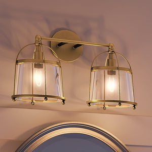 Two beautiful Juneau Collection lighting fixtures above a mirror in a bathroom.