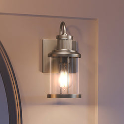 A gorgeous Urban Ambiance UEX2590 Americana Wall Sconce lamp with a satin nickel finish, from the Torrington Collection, beautifully complements a mirror.