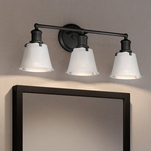 A Beautiful Urban Ambiance Modern Farmhouse Bath Light 9''H x 24''W, Charcoal Finish, Providence Collection with three lights and a mirror.
