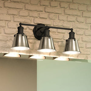 Three UEX2645 Modern Farmhouse Bath Light 9''H x 24''W, Charcoal Finish, Providence Collection bathroom fixture with a brick wall, offering a unique and gorgeous ambiance.