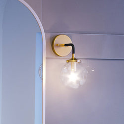 A beautiful bathroom with a unique UEX2700 Modern Wall Sconce 12''H x 6''W, Antique Gold & Matte Black Finish, Lakewood Collection light fixture by