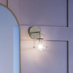 An Urban Ambiance UEX2710 Industrial Lux Wall Sconce 10''H x 6''W with a beautiful mirror on it.