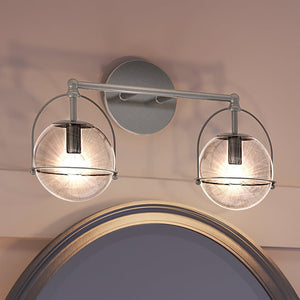An Urban Ambiance bathroom light with two unique UEX2711 Industrial Bath Light 10''H x 17''W, Satin Nickel Finish, Charlotte Collection glass globes hanging above a mirror