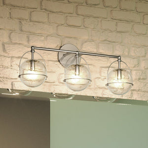 A bathroom with a beautiful and unique Urban Ambiance UEX2712 Industrial Bath Light 10''H x 24''W, Satin Nickel Finish, Charlotte Collection light fixture and a brick wall