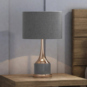 A beautiful UEX7000 Glam Table Lamp with a grey shade and a rose gold base, from the Sedona Collection by Urban Ambiance.