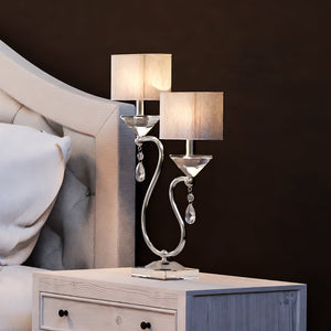 A bed with the gorgeous UEX7010 Glam Table Lamp lighting fixture on top of it.