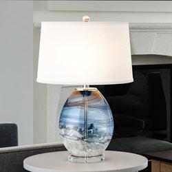 A gorgeous lighting fixture, the UEX7100 Nautical Table Lamp from the Decorah Collection features a clear blue and white finish with a white shade and stunning blue glass.
