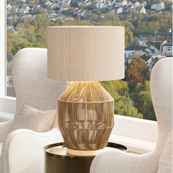 A beautiful UEX7140 Scandinavian Table Lamp lighting fixture on a table in front of a window.