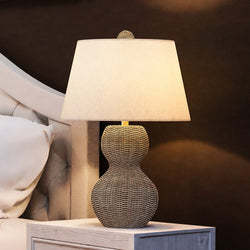 A unique lamp by Urban Ambiance sits on a bed.