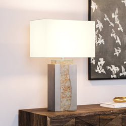 A gorgeous UEX7230 Modern-Rustic lighting fixture lamp with a white shade on a wooden table from the Urban Ambiance brand.