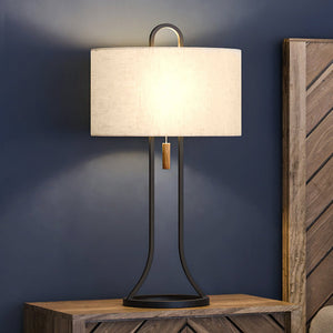 A luxury bed with a Mid-Century-Modern table lamp, Dark Bronze Finish.