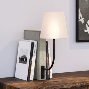 An Urban Ambiance UEX7490 Mid-Century-Modern Desk Lamp, Polished Concrete and Black Finish, Davis Collection with books on top of it.